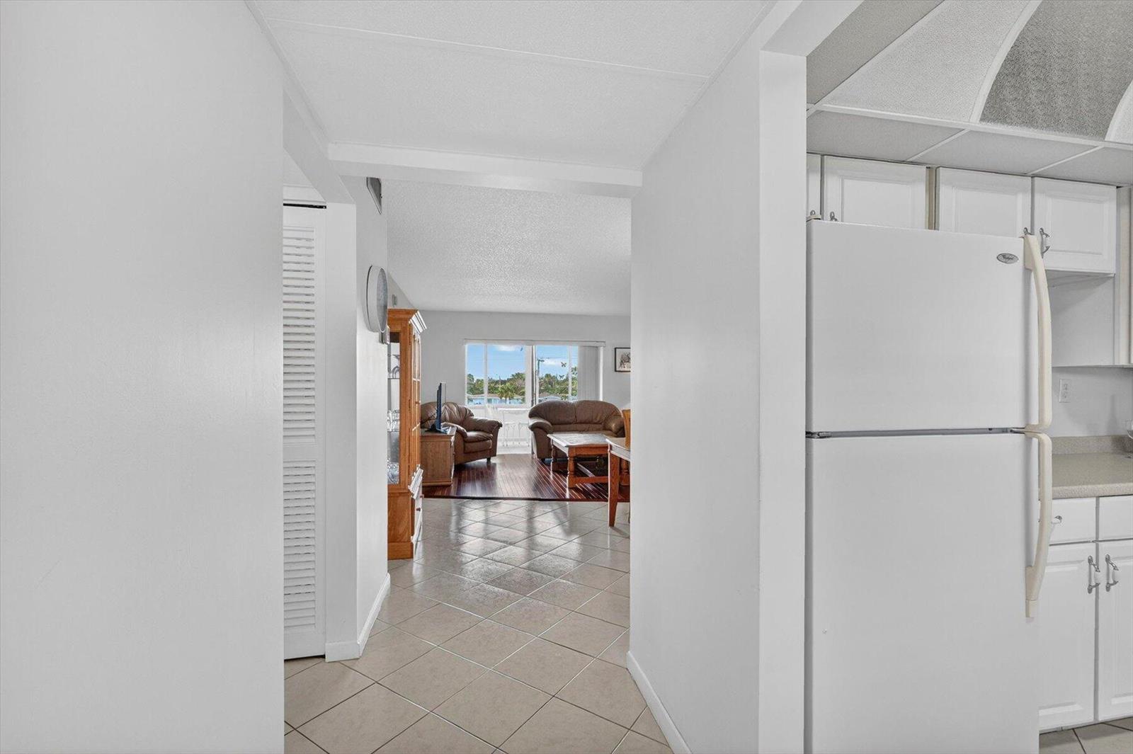 A view from a tiled hallway looking into a living room with brown furniture — 7787 Golf Circle Drive # k, Margate FL 33063, MARGATE, FL