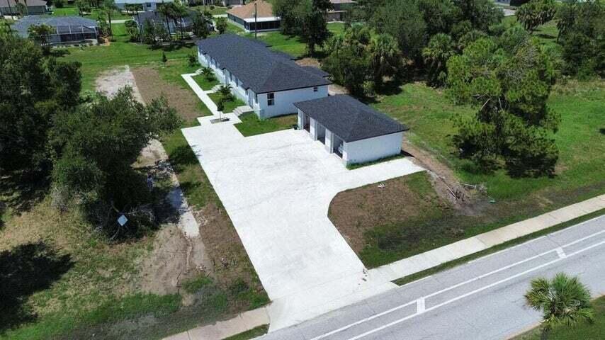 An aerial view of a white house with a dark roof and a detached garage — 260 W Rotonda Blvd W # 3, FL 33947, FL