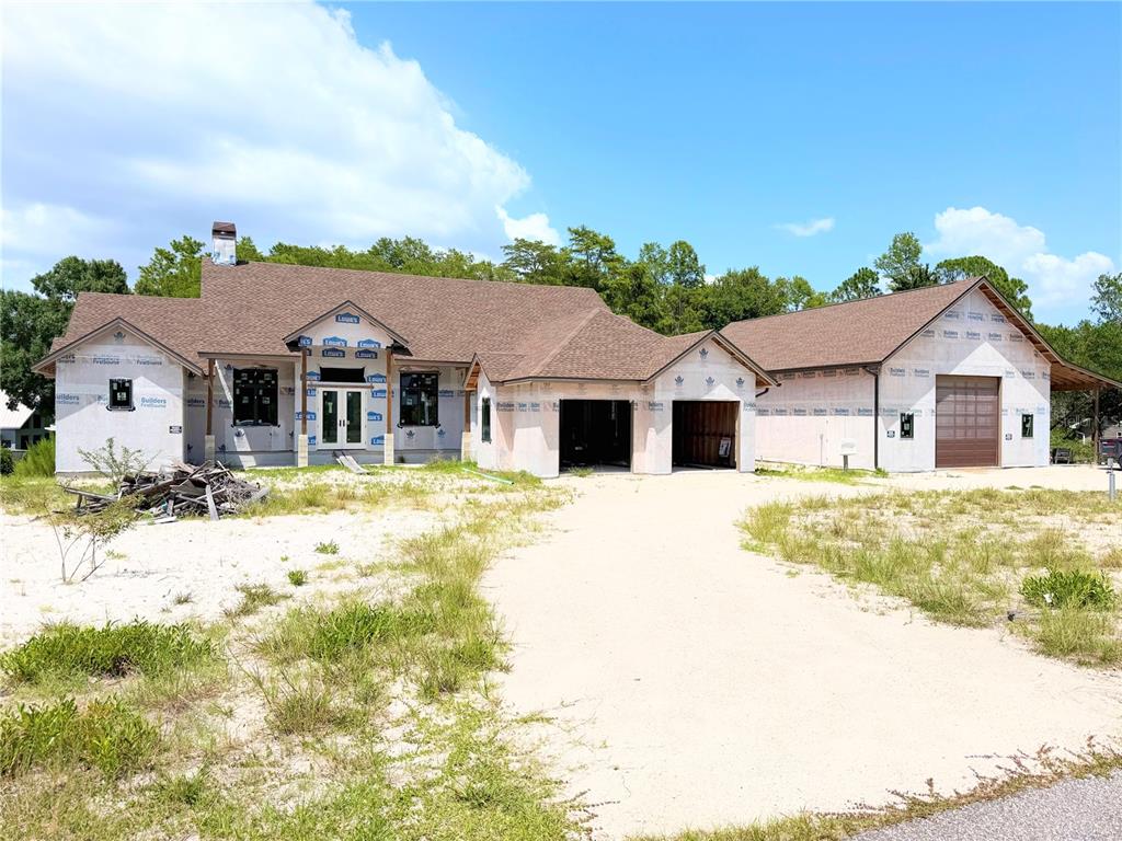 A new construction house with a brown shingled roof and unfinished exterior walls — 7640 MOKENA COURT, NEW PORT RICHEY, FL