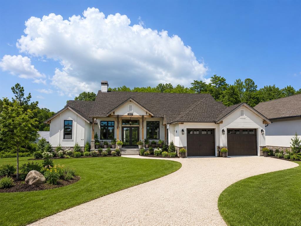 A single-story house with a white exterior, dark roof, and a gravel driveway — 7640 MOKENA COURT, NEW PORT RICHEY, FL