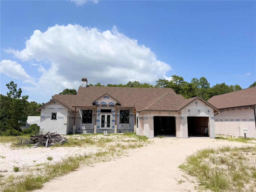 A single-story house under construction with a brown shingled roof and unfinished exterior walls — 7640 MOKENA COURT, NEW PORT RICHEY, FL