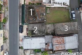 This is an aerial view of a property featuring three numbered buildings and a yard — PALO SECO PALO SECO, TOA BAJA, PR
