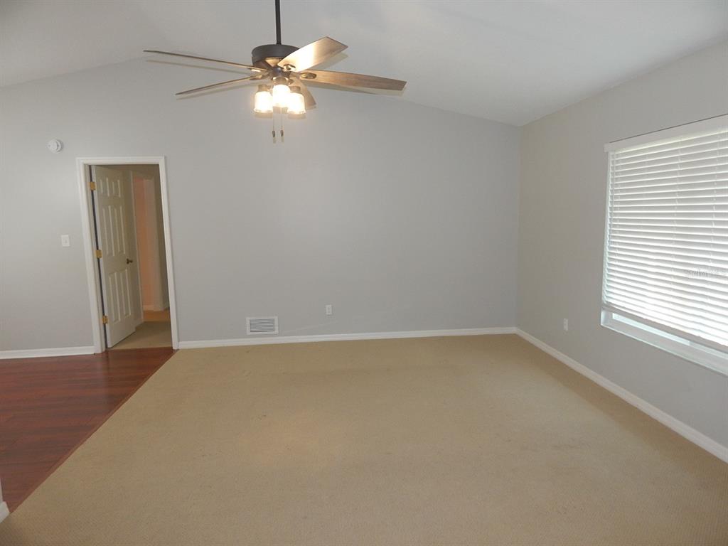 A room with beige carpet, light gray walls, a ceiling fan, and a window with blinds — 4660 CREEKVIEW LANE, OVIEDO, FL