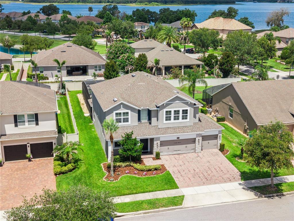 An aerial view shows a two-story suburban house with a three-car garage and driveway — 16044 CITRUS KNOLL DRIVE, WINTER GARDEN, FL
