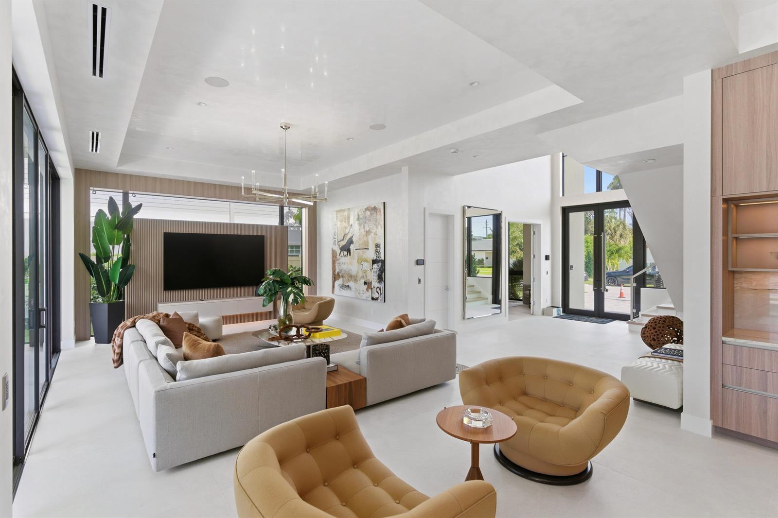 A modern living room features a large sectional sofa, two tan armchairs, and a television — 511 Silver Lane, Boca Raton FL 33432, BOCA RATON, FL