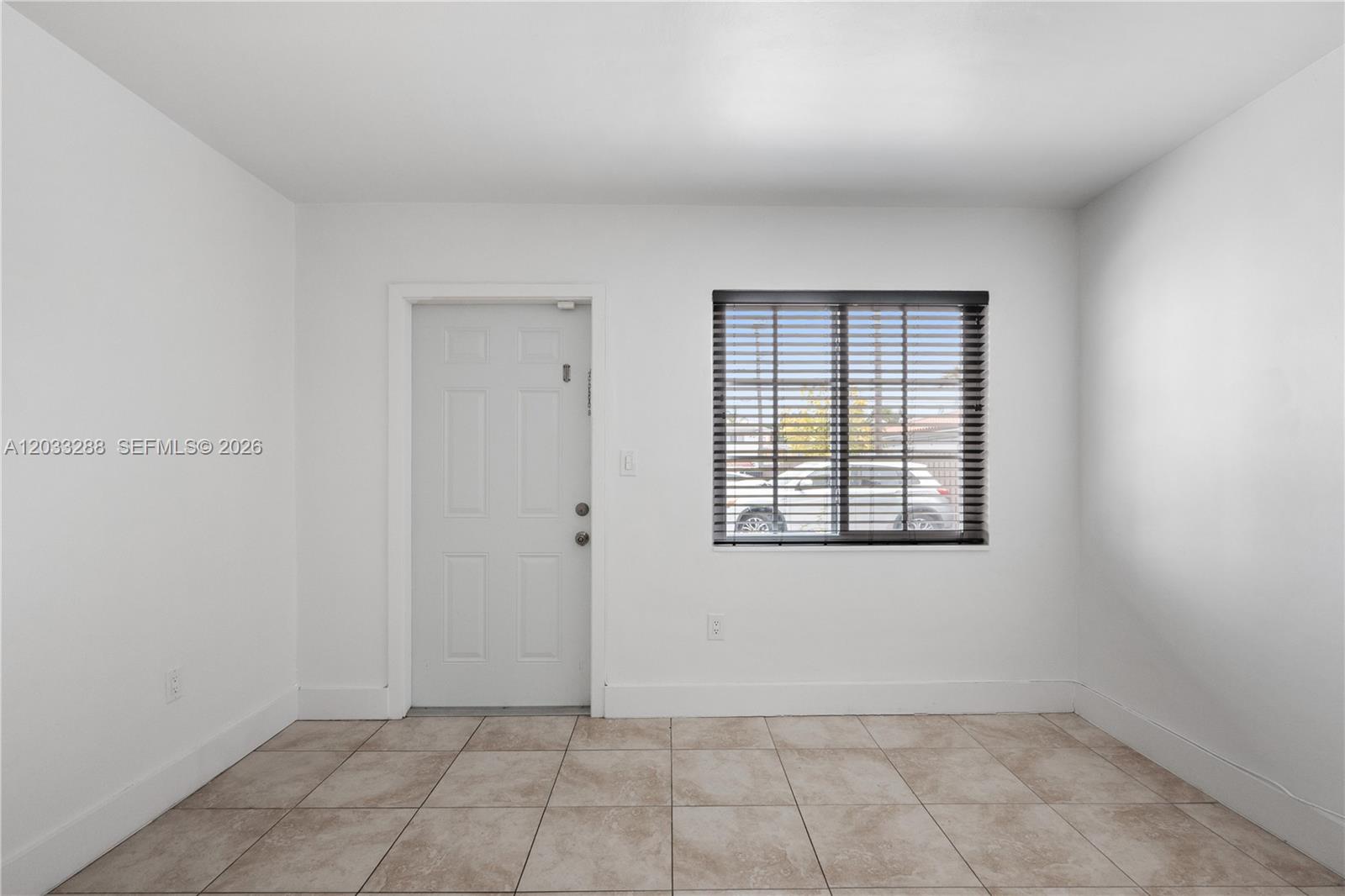 A room with white walls, tiled flooring, a white door, and a window with blinds — 932 SW 6th St # 5, Miami FL 33130, MIAMI, FL