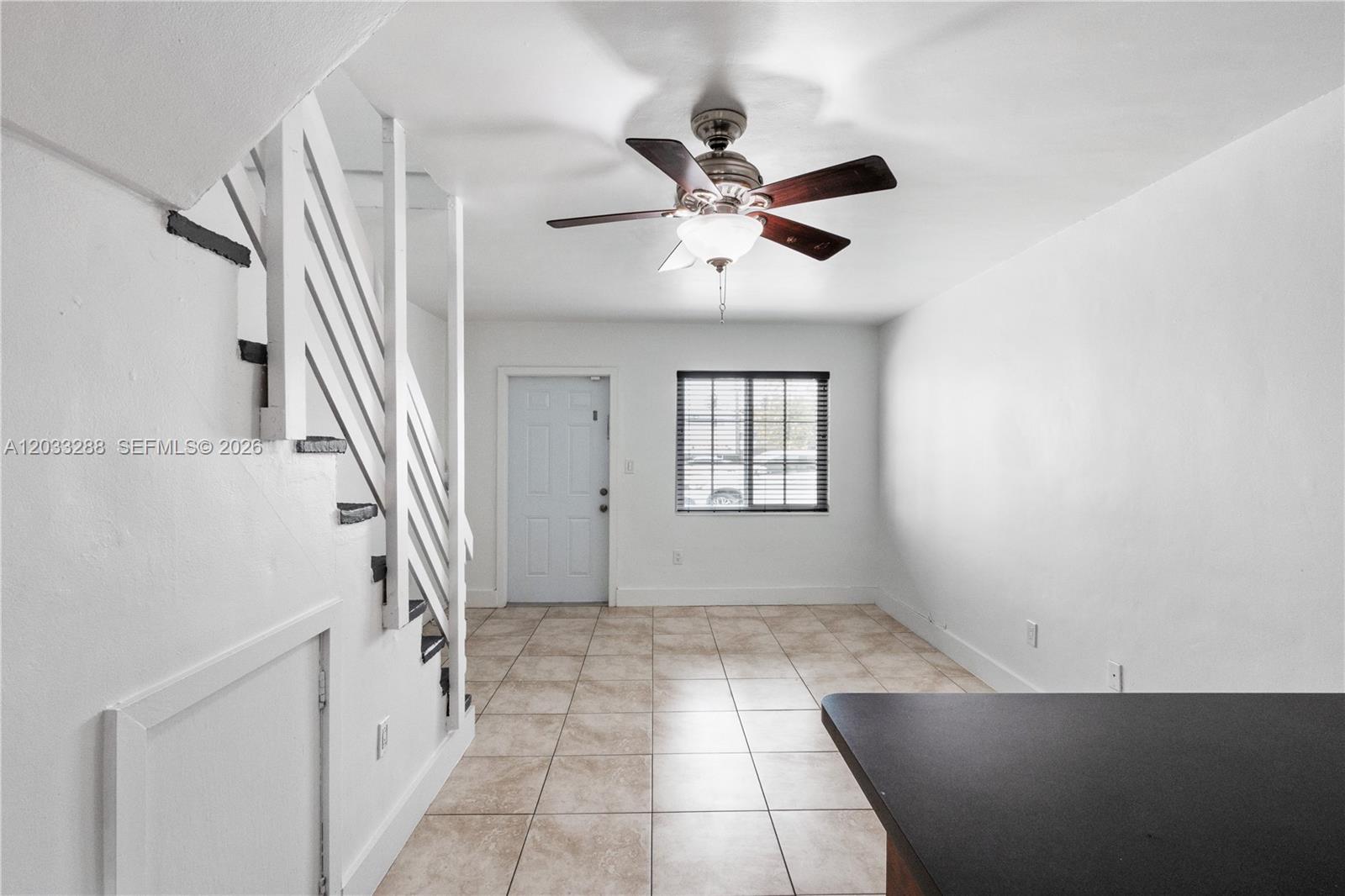 A room with white walls, tile flooring, a ceiling fan, and a staircase — 932 SW 6th St # 5, Miami FL 33130, MIAMI, FL