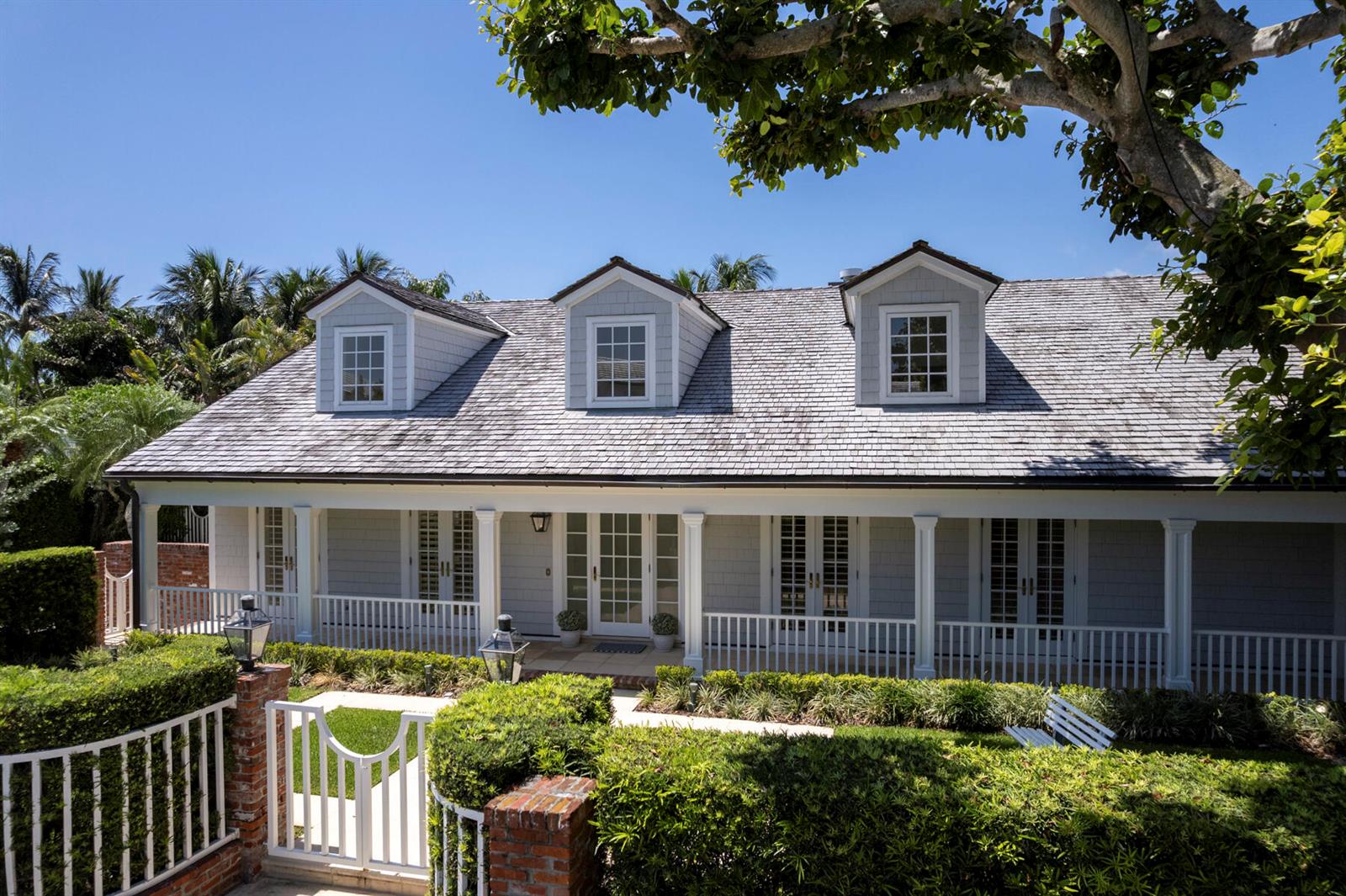 A gray, two-story house with a shingled roof, dormer windows, and a white front porch — 222 Monterey Road, Palm Beach FL 33480, PALM BEACH, FL