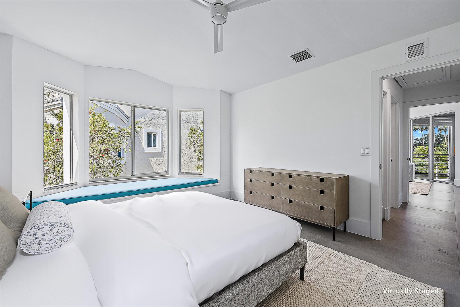 A bedroom features a bay window with a blue seat, a dresser, and white walls — 802 Captains Way, Jupiter FL 33477, JUPITER, FL