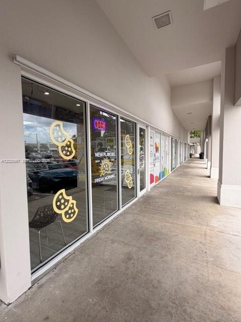 A storefront with glass windows and cookie decals along a covered outdoor walkway — 10730 NW 58 STREET, Doral FL 33178, DORAL, FL