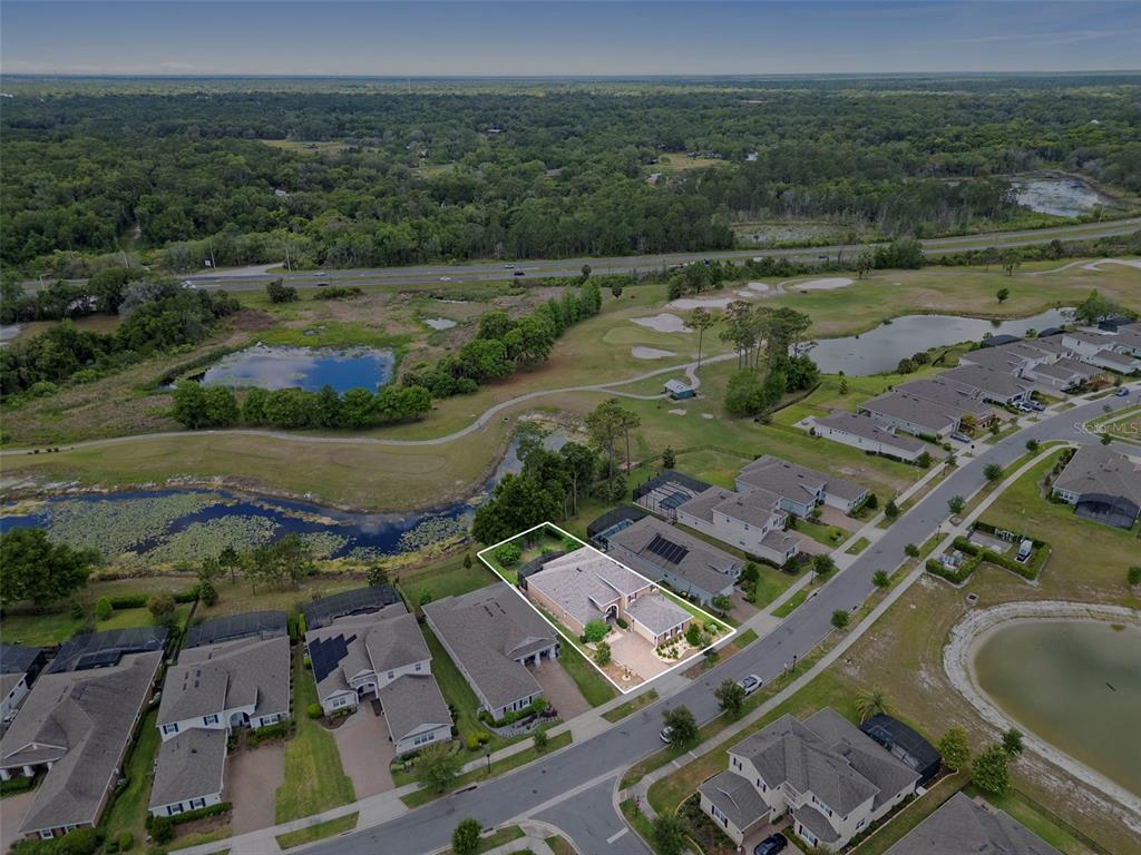An aerial view shows a single-story house with a white outline situated in a suburban neighborhood — 1022 VICTORIA HILLS DRIVE S, DELAND, FL