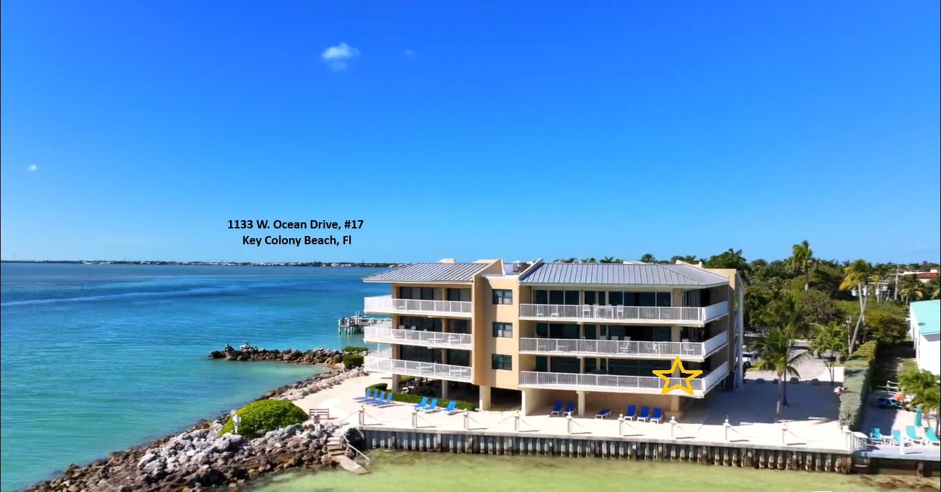 An aerial view of a multi-story waterfront condominium building with balconies overlooking the ocean — 1133 W Ocean Drive # 17, FL 33050, FL