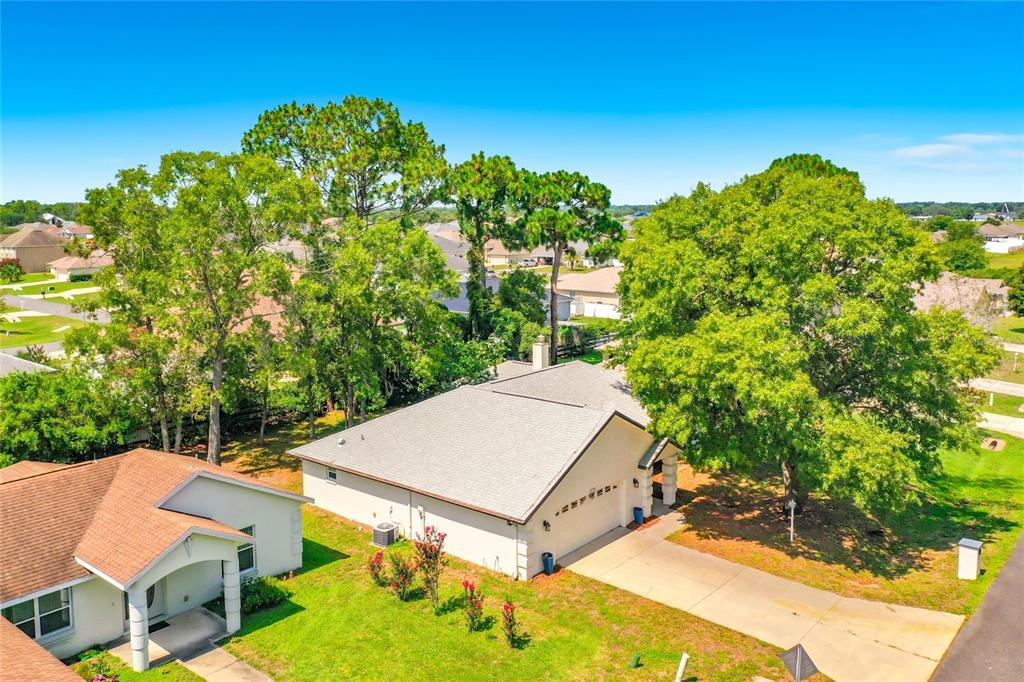 An aerial view shows a single-story house with a light-colored roof and a concrete driveway — 9537 SW 53RD CIRCLE, OCALA, FL