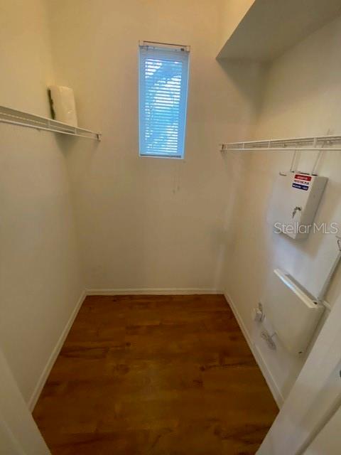 A walk-in closet with wood-look flooring, white walls, wire shelving, and a small window — 2010 E PALM AVENUE UNIT 15208, TAMPA, FL