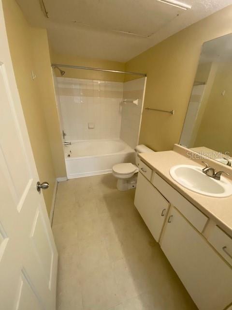 A bathroom features a white vanity, a toilet, and a shower-tub combination with white tiles — 2010 E PALM AVENUE UNIT 15208, TAMPA, FL