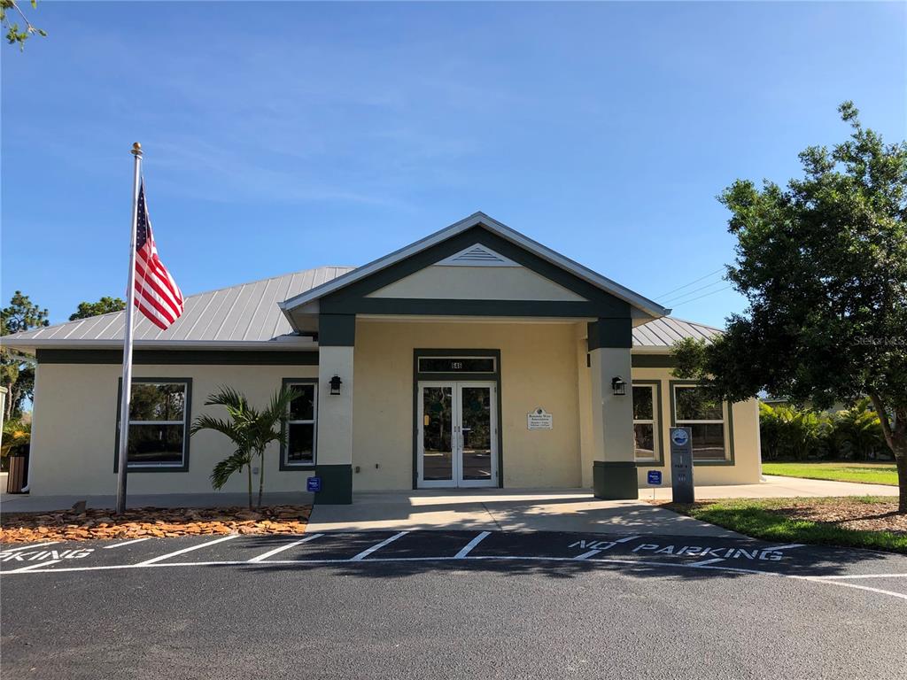 A single-story building with a metal roof, a flag pole, and a parking lot — 1153 BOUNDARY BOULEVARD, ROTONDA WEST, FL