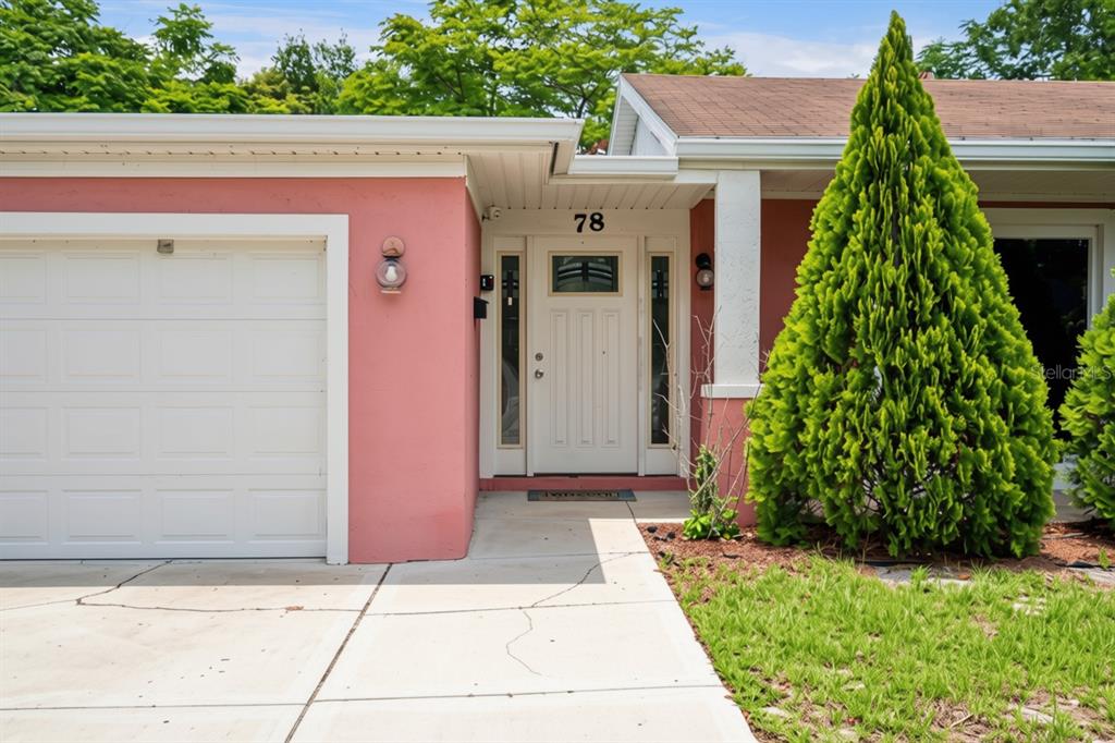 An entryway features a blue console table, a fire alarm panel, and a white door — 78 S WINTER PARK DRIVE, CASSELBERRY, FL