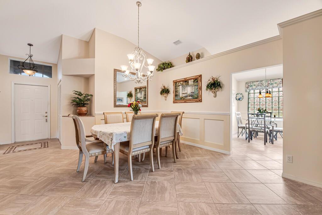 A dining room with tile floors, a chandelier, and a table set for four people — 8294 Duomo Circle, Boynton Beach FL 33472, BOYNTON BEACH, FL