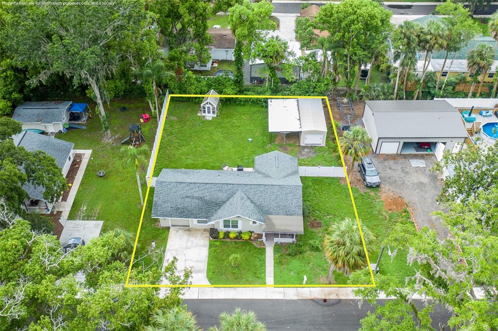 An aerial view shows a single-story house with a fenced backyard, shed, and detached garage — 5708 HOMECREST ROAD, NEW PORT RICHEY, FL