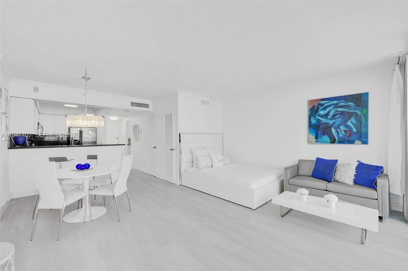 A studio apartment features a dining area, a bed, and a sofa on light flooring — 2501 S Ocean Dr, Hollywood FL 33019, HOLLYWOOD, FL