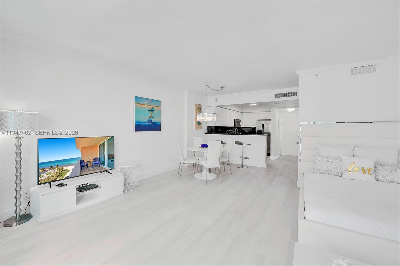 A studio apartment features white flooring, a kitchen, a dining area, and a bed — 2501 S Ocean Dr, Hollywood FL 33019, HOLLYWOOD, FL