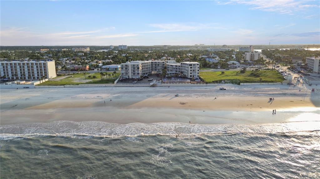 A small kitchen and dining area with a view of the beach through sliding doors — 1233 S ATLANTIC AVENUE UNIT 2270, DAYTONA BEACH, FL