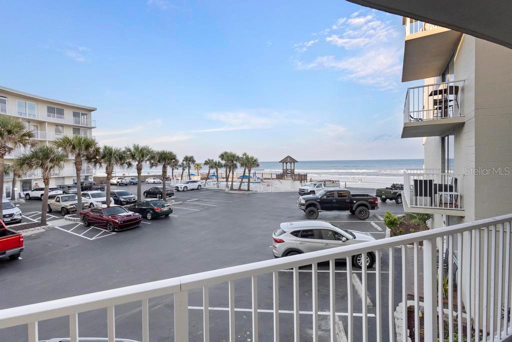 An outdoor rectangular swimming pool is surrounded by a brick paver deck and oceanfront fencing — 1233 S ATLANTIC AVENUE UNIT 2270, DAYTONA BEACH, FL