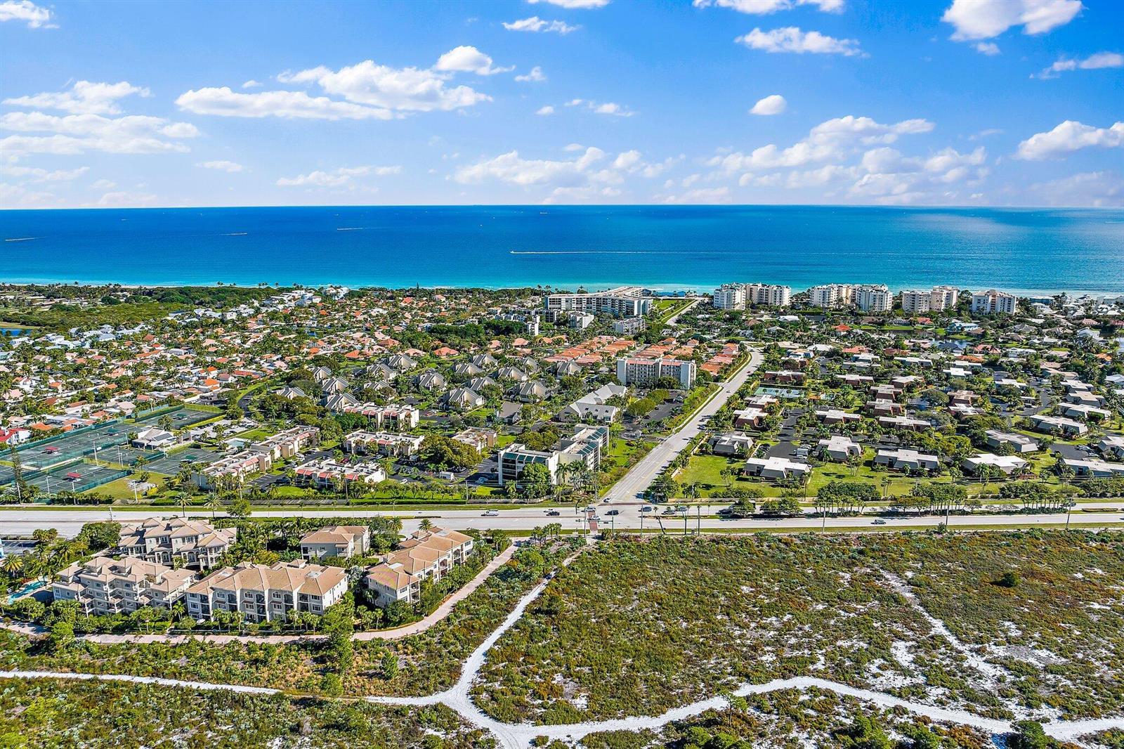 An aerial view of a coastal residential neighborhood with multi-story buildings and a sandy path — 1605 S Us Highway 1 # 506, Jupiter FL 33477, JUPITER, FL