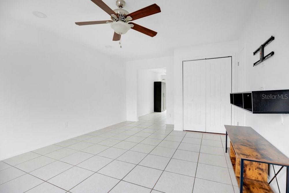 A room with white walls, light tile flooring, a ceiling fan, and a wall-mounted desk — 611 CASA PARK A COURT, WINTER SPRINGS, FL