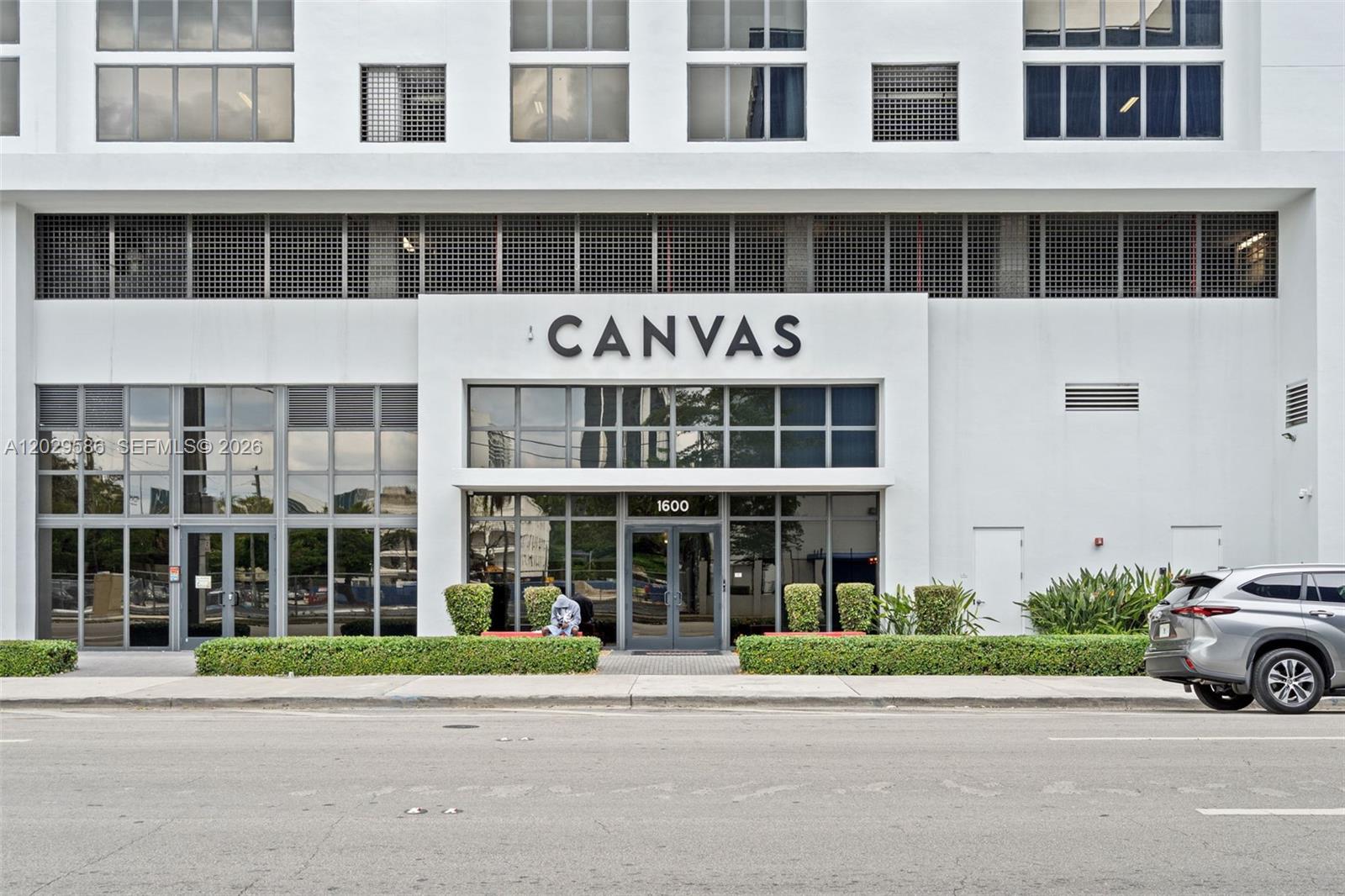 The exterior of a modern white building features a large sign reading CANVAS above glass doors — 1600 NE 1st Ave # 2617, Miami FL 33132, MIAMI, FL