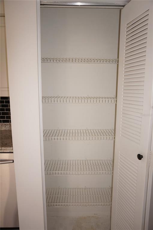 A pantry with five white wire shelves and a louvered door — 13100 S MCCALL ROAD UNIT 184, PORT CHARLOTTE, FL