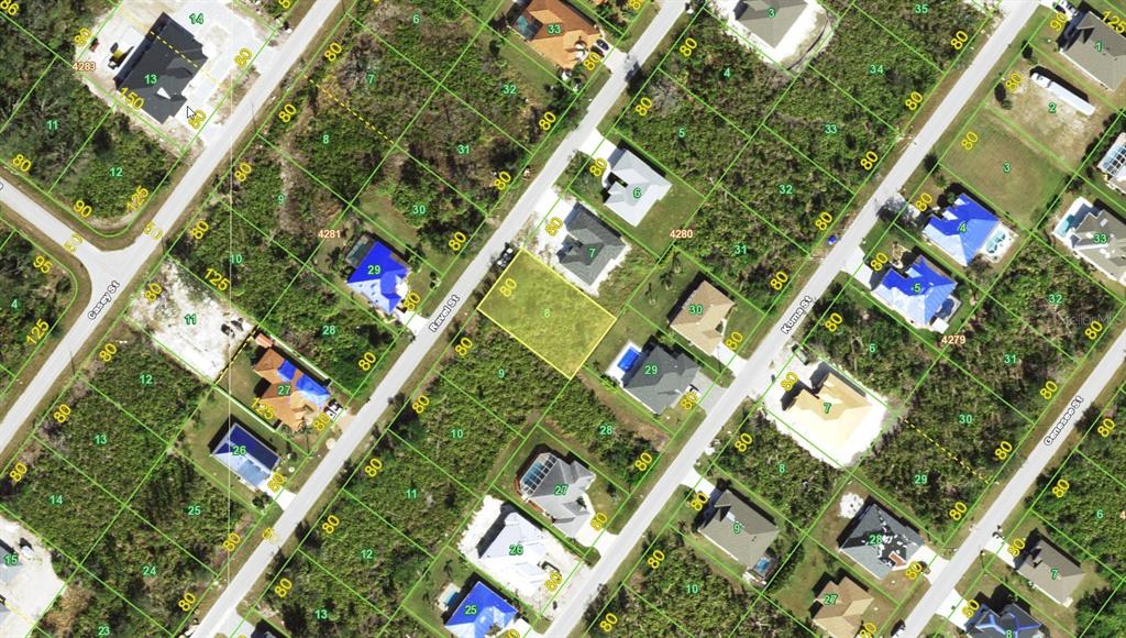 This is an aerial map showing a vacant lot highlighted in yellow among residential properties — 9164 RAVEL STREET, PORT CHARLOTTE, FL