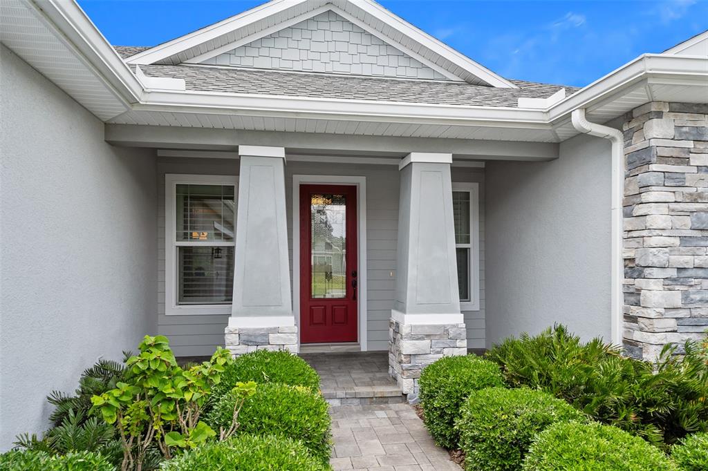 A single-story house with a paved driveway, two-car garage, and a large palm tree — 3322 MODENA WAY, NEW SMYRNA BEACH, FL