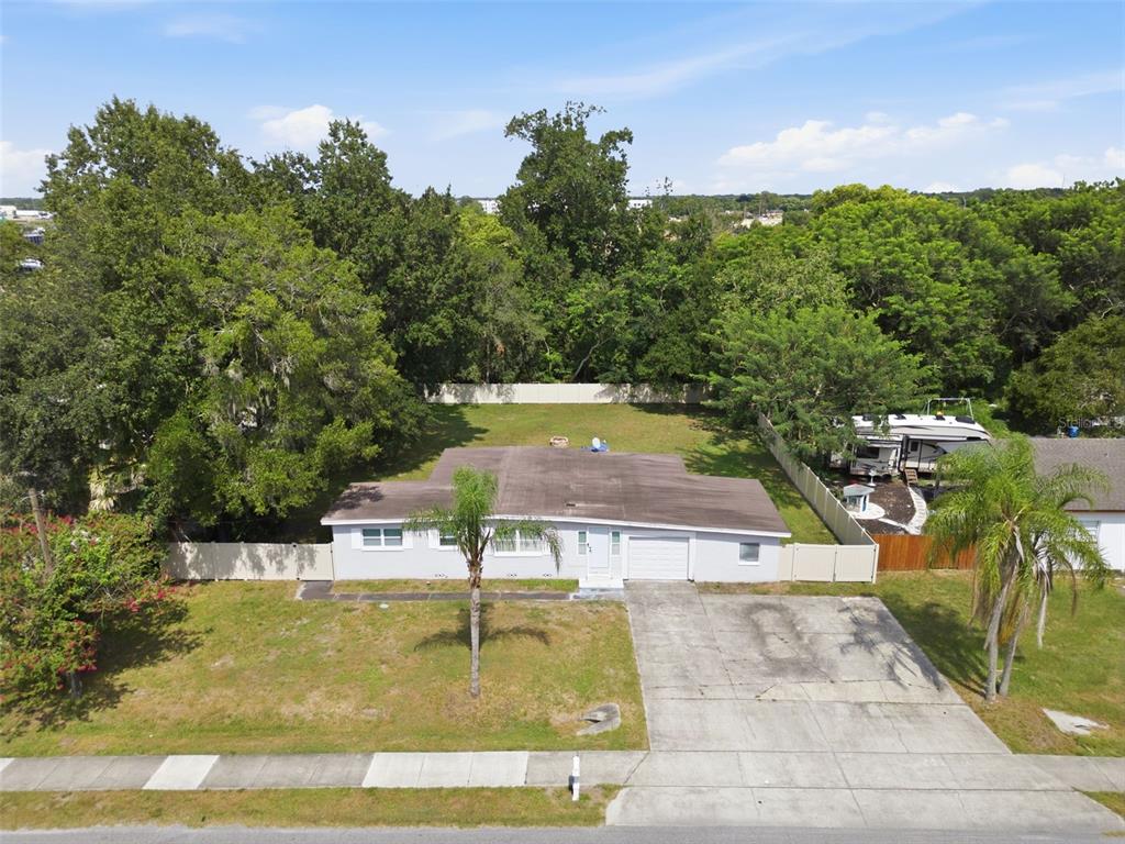 An aerial view shows a single-story house with a concrete driveway and a large backyard — 1601 RENEE AVENUE, ORLANDO, FL