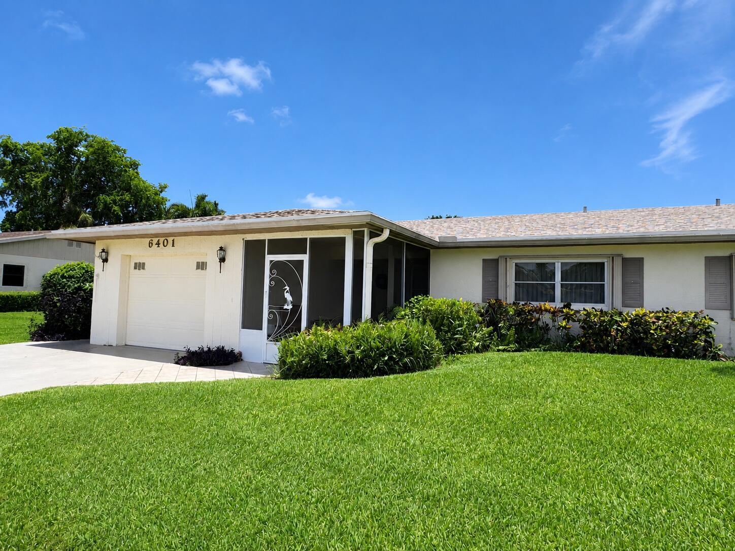 A single-story house with a white exterior, a garage, and a screened-in front entryway — 6401 Lasalle Drive, Delray Beach FL 33484, DELRAY BEACH, FL