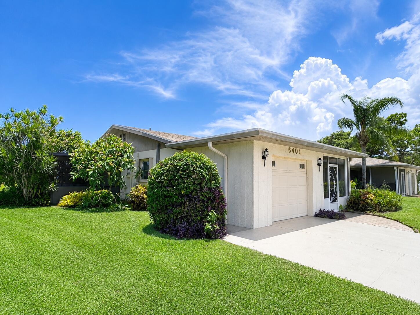 A single-story house with a white exterior, a one-car garage, and a manicured front lawn — 6401 Lasalle Drive, Delray Beach FL 33484, DELRAY BEACH, FL