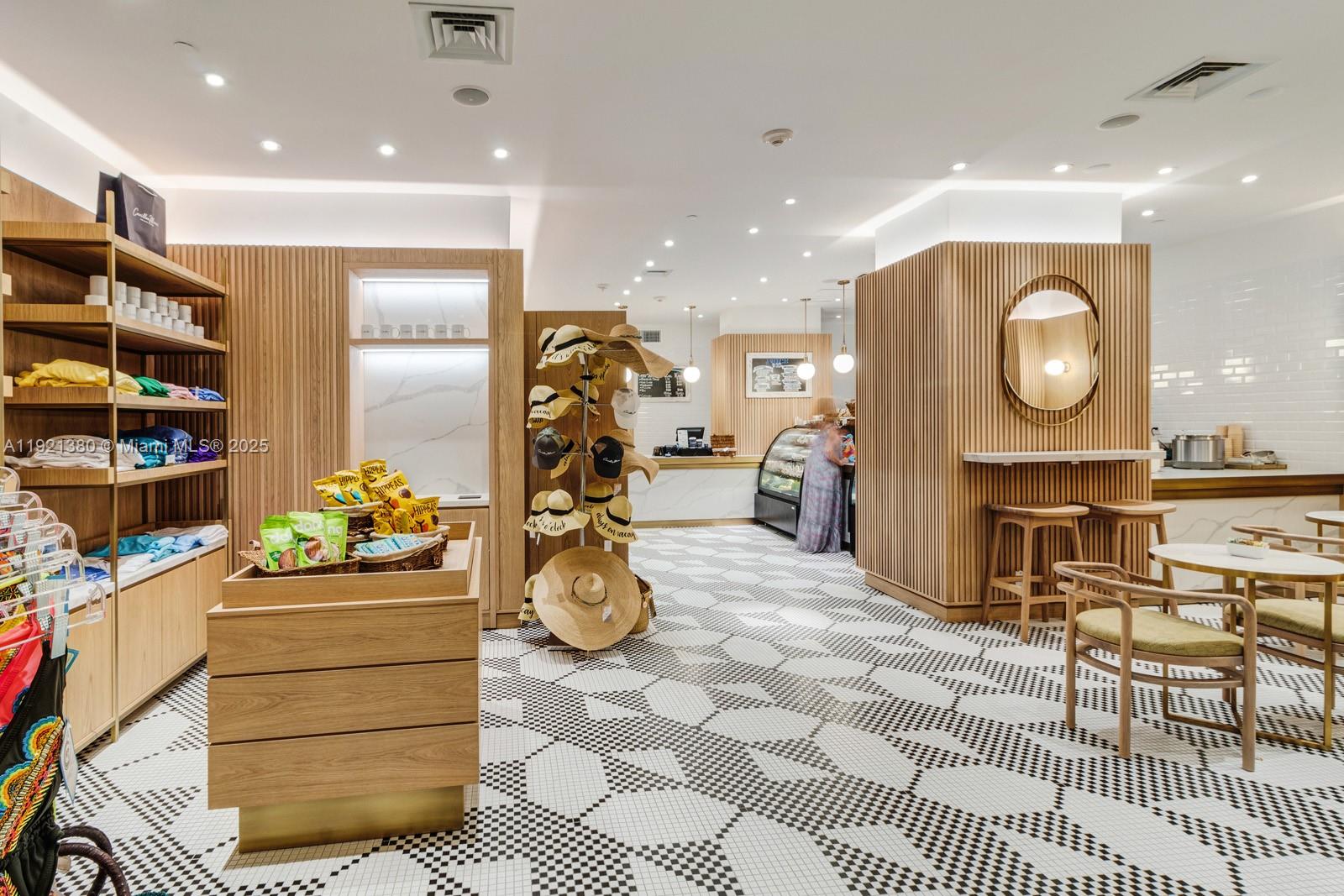 A retail shop features light wood paneling, a geometric tiled floor, and a display of hats — 6801 Collins Ave # 320, Miami Beach FL 33141, MIAMI BEACH, FL
