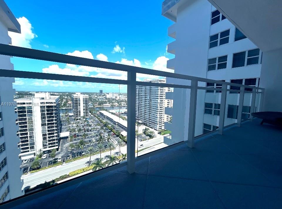 An aerial view of a sandy beach with palm trees, umbrellas, and people swimming — 2030 S Ocean Dr # 1802, Hallandale Beach FL 33009, HALLANDALE BEACH, FL