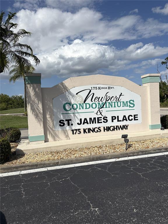 A sign for Newport Condominiums and St. James Place stands near a paved road — 175 KINGS HIGHWAY UNIT A1, PUNTA GORDA, FL