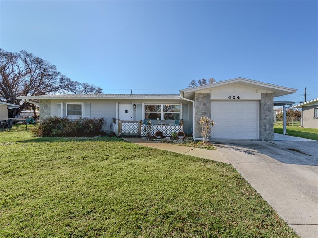 A single-story house with a light-colored exterior, stone accents, and an attached one-car garage — 424 CENTER ROAD, VENICE, FL