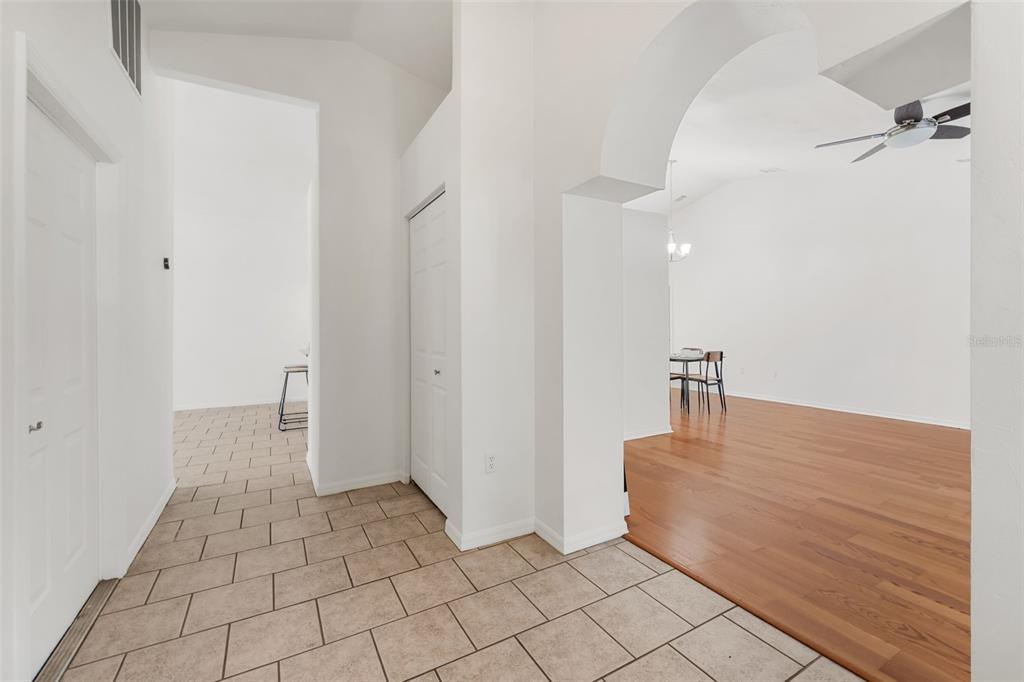 A tiled entryway leads to a living area with hardwood floors and an arched opening — 6220 SW 81ST STREET, GAINESVILLE, FL