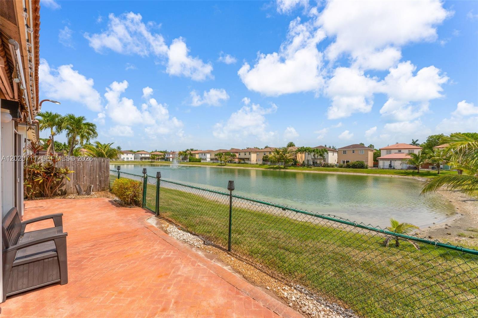 A patio with a bench overlooks a lake and a residential neighborhood — 11318 NW 44th Ter, Doral FL 33178, DORAL, FL