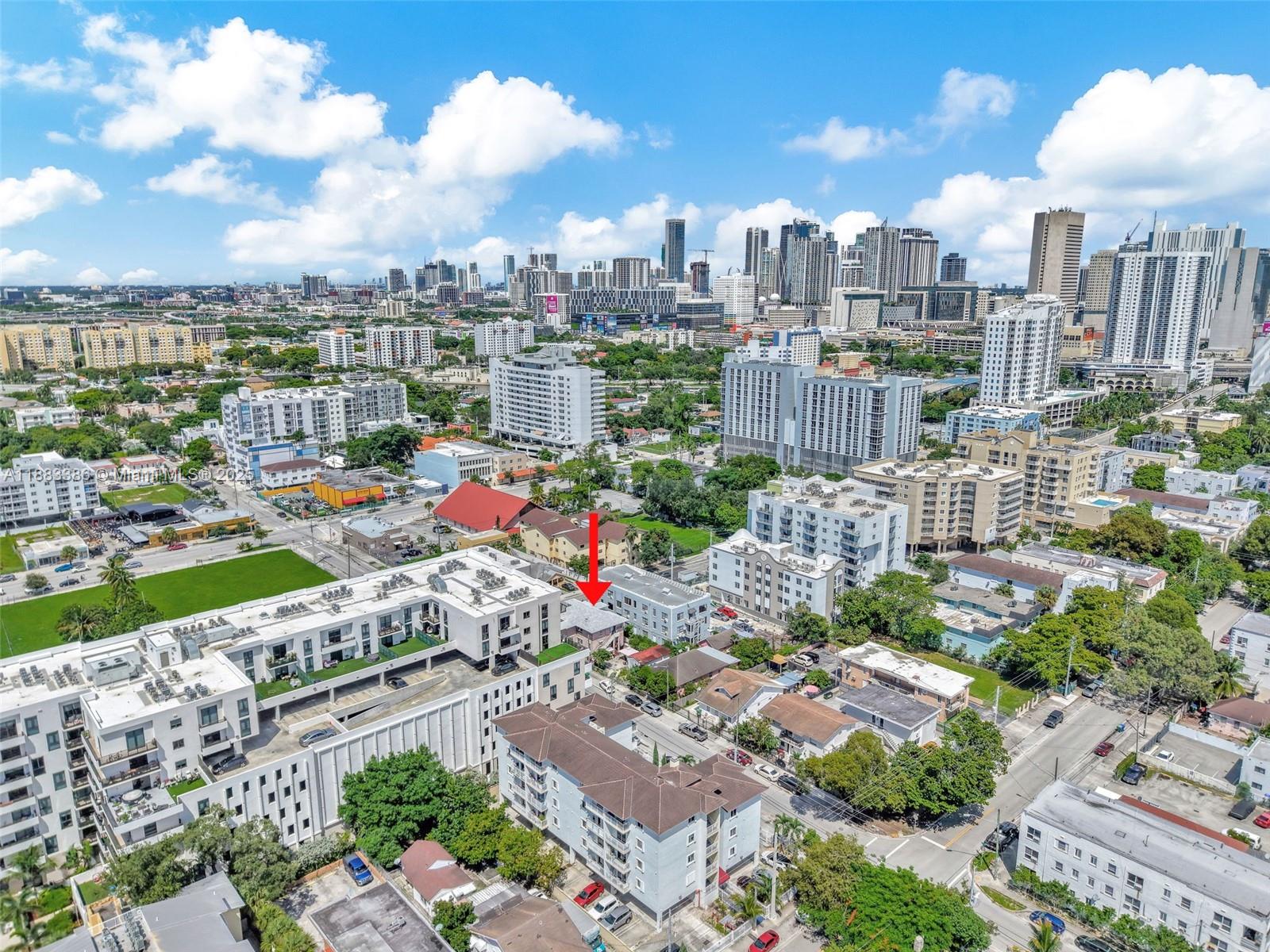 An aerial view shows a dense urban neighborhood with a red arrow pointing toward a building — 676 & 119 SW 1st St, Miami FL 33130, MIAMI, FL