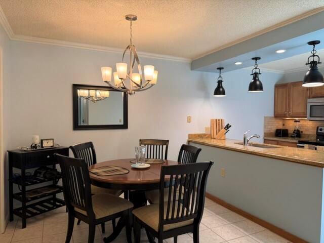 A dining area with a round table and chairs sits adjacent to a kitchen counter — 1604 16th Court, Jupiter FL 33477, JUPITER, FL