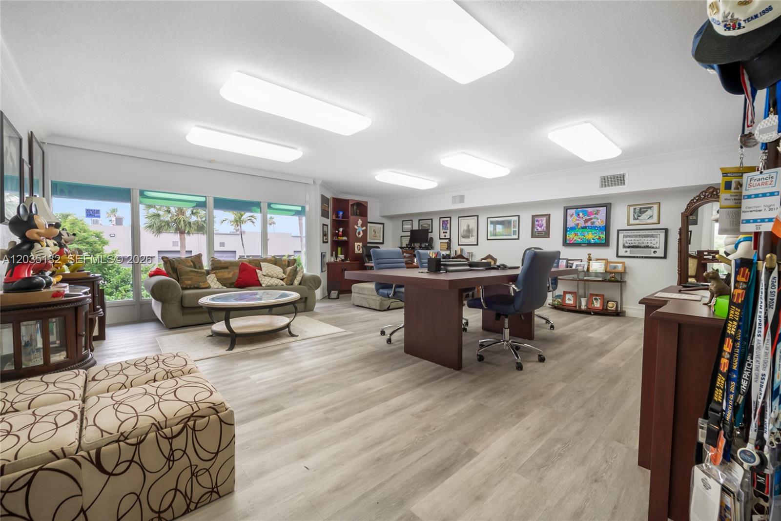 A spacious office with light wood flooring, a large conference table, and a seating area — 16155 SW 117th Ave # B21, Miami FL 33177, MIAMI, FL