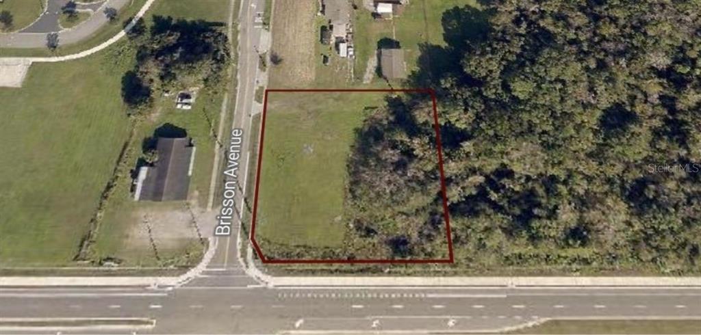 An aerial view shows a rectangular vacant lot outlined in red next to a road — 0 BRISSON AVENUE AVENUE, SANFORD, FL