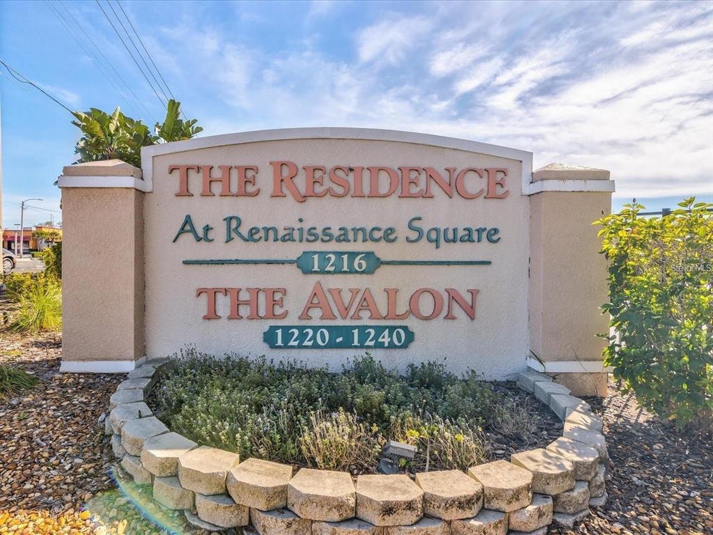 A stone monument sign displays the names of two apartment complexes and their building numbers — 1216 S MISSOURI AVENUE UNIT 317, CLEARWATER, FL
