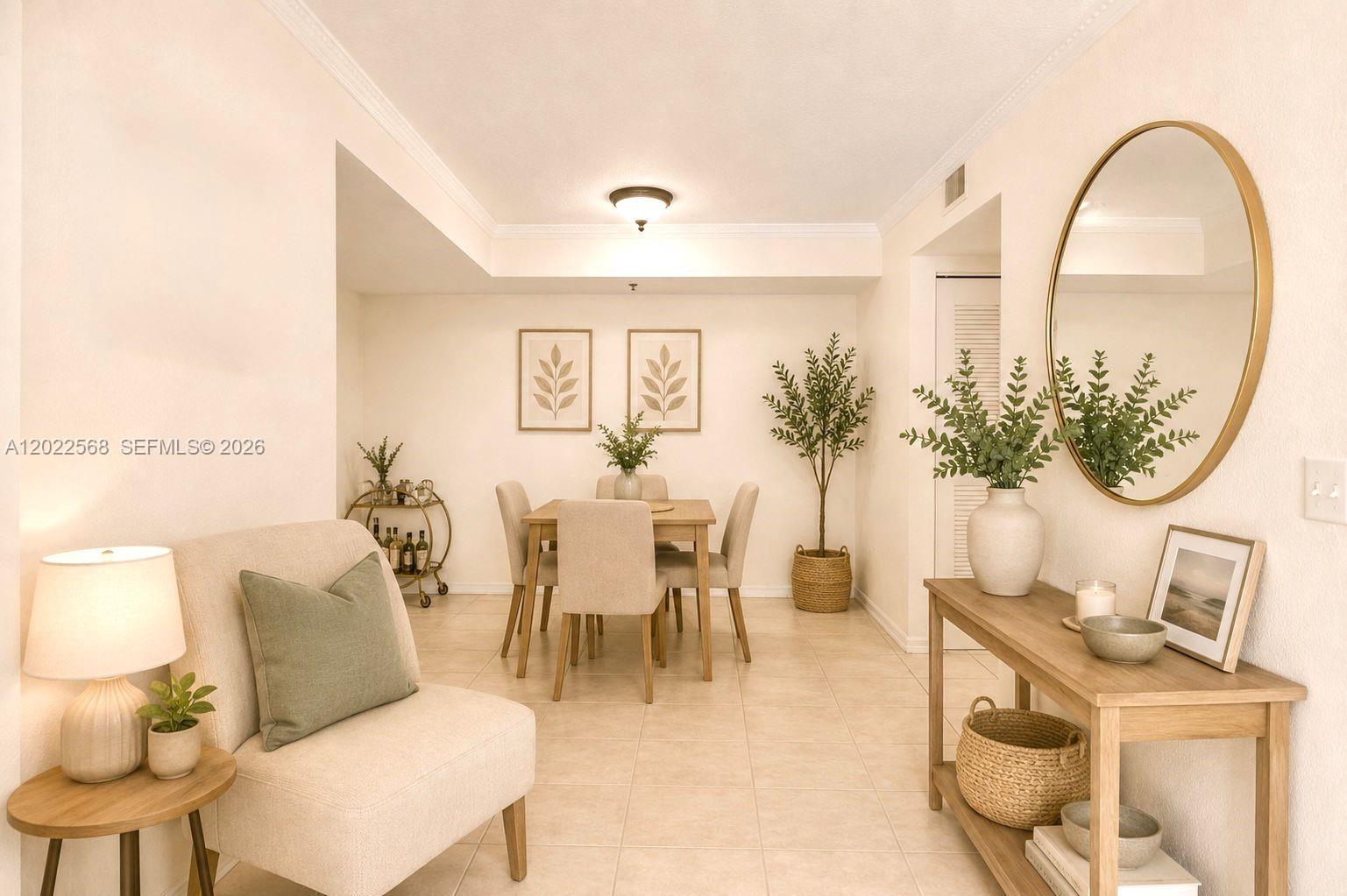 A dining area features a wooden table, chairs, a console table, and a round mirror — 814 NW 36th Ave # 302, Miami FL 33125, MIAMI, FL