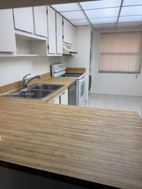 A kitchen features wood-grain laminate countertops, white cabinets, a double sink, and a white stove — 400 Commodore Dr # 108, Plantation FL 33325, PLANTATION, FL