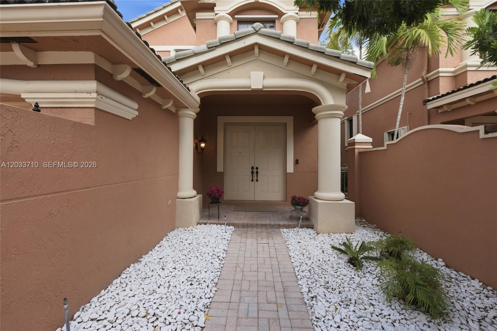 A paved walkway leads to the double front doors of a stucco house with columns — 2794 Kinsington Cir # 3, Weston FL 33332, WESTON, FL